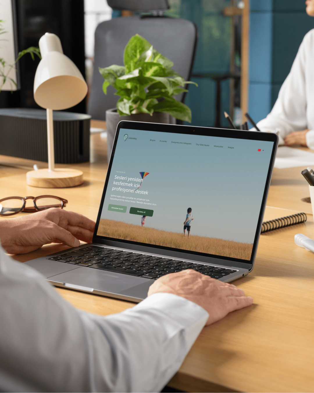 Listenway website shown on a laptop in a studio workspace
